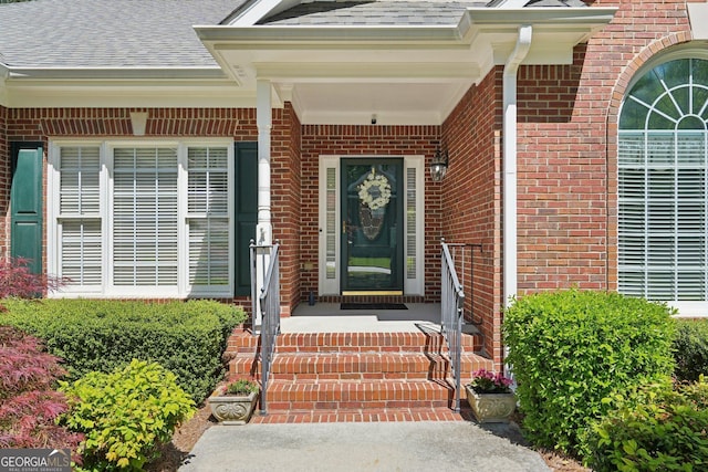 2545 Amberbrook Ln, Grayson, GA 30017 - view of exterior entry with a shingled roof and brick siding