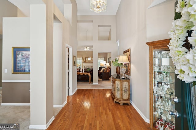 2545 Amberbrook Ln, Grayson, GA 30017 - foyer entrance with wood finished floors, a towering ceiling, baseboards, and a notable chandelier