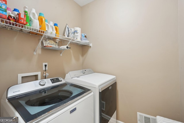 2545 Amberbrook Ln, Grayson, GA 30017 - laundry room featuring visible vents, baseboards, washer and dryer, and laundry area