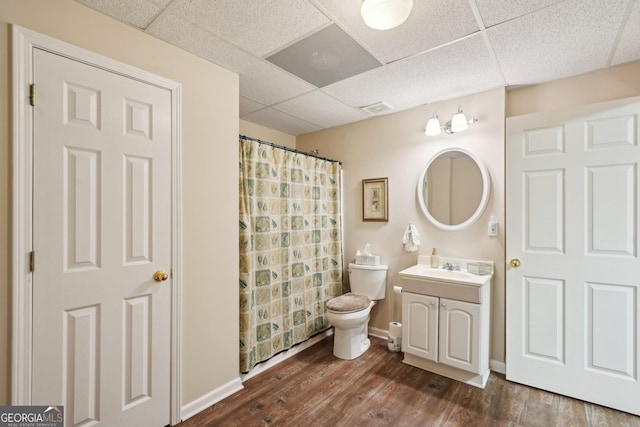 2545 Amberbrook Ln, Grayson, GA 30017 - full bathroom featuring vanity, toilet, visible vents, a drop ceiling, and wood finished floors