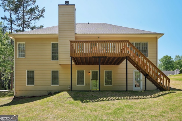 2545 Amberbrook Ln, Grayson, GA 30017 - back of property with a yard, stairway, a chimney, a shingled roof, and a deck
