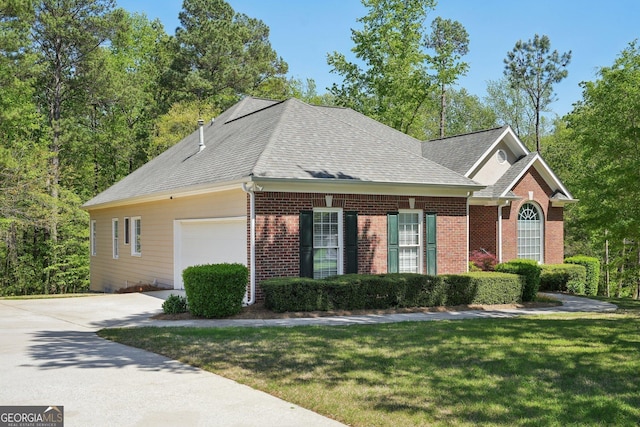 2545 Amberbrook Ln, Grayson, GA 30017 - view of front of home with concrete driveway, a front lawn, brick siding, a garage, and a shingled roof