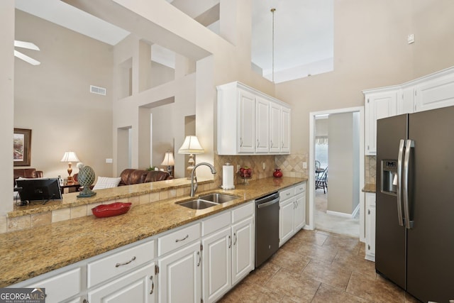 2545 Amberbrook Ln, Grayson, GA 30017 - kitchen with a sink, visible vents, appliances with stainless steel finishes, and a towering ceiling