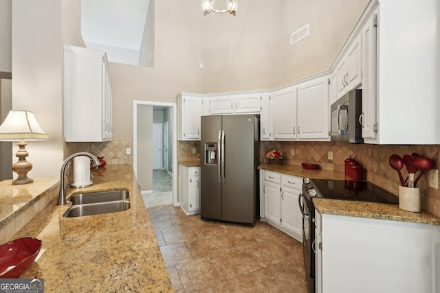 2545 Amberbrook Ln, Grayson, GA 30017 - kitchen with white cabinetry, visible vents, a high ceiling, appliances with stainless steel finishes, and a sink