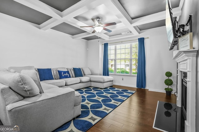 living room with baseboards, a fireplace, beam ceiling, ceiling fan, and wood finished floors