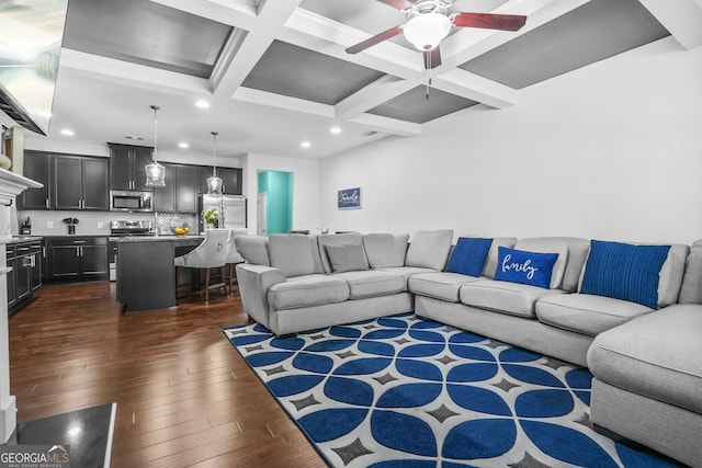 living area with recessed lighting, a ceiling fan, dark wood-type flooring, beam ceiling, and coffered ceiling