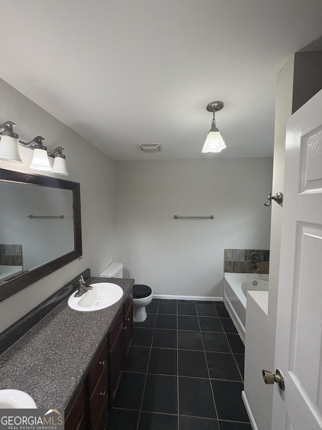 full bathroom featuring a bath, vanity, tile patterned flooring, toilet, and baseboards