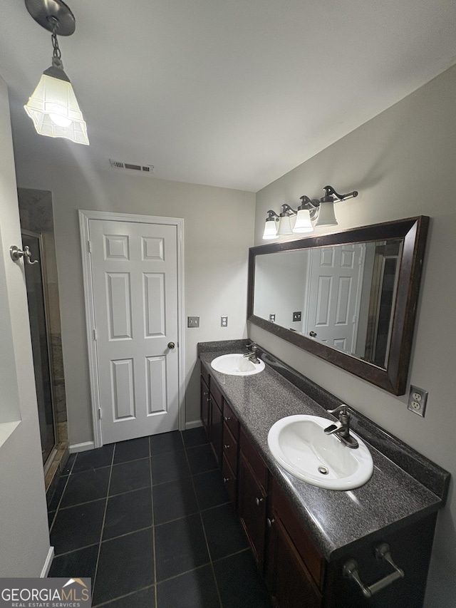 bathroom featuring tile patterned floors, double vanity, a sink, and visible vents