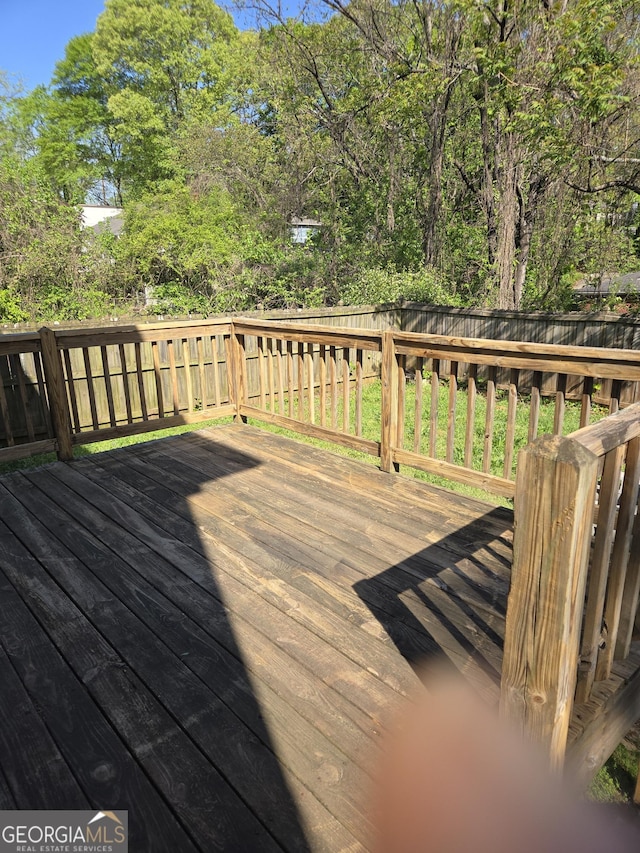 wooden terrace featuring a fenced backyard