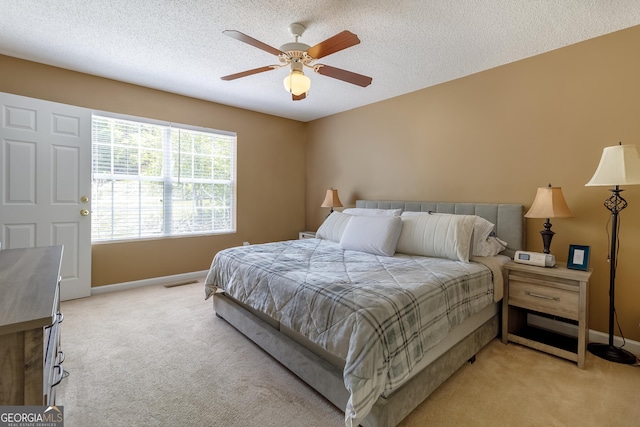 bedroom featuring visible vents, baseboards, and light colored carpet