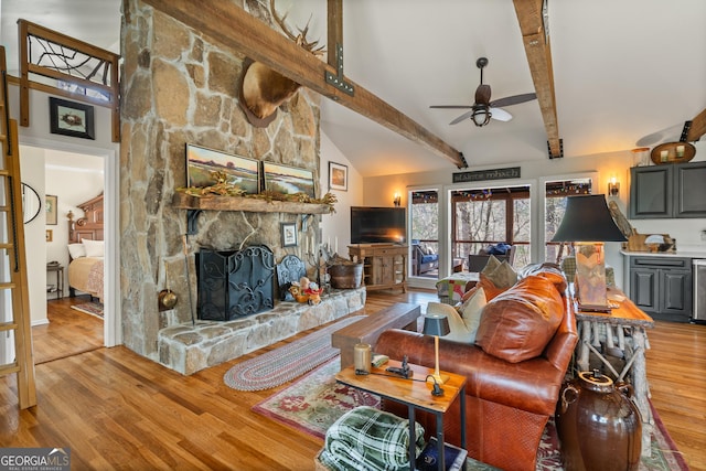 426 Crow Creek Rd, Lakemont, GA 30552 - living room featuring a ceiling fan, a stone fireplace, and wood finished floors