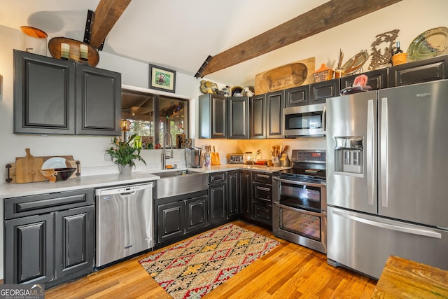 426 Crow Creek Rd, Lakemont, GA 30552 - kitchen featuring stainless steel appliances, beamed ceiling, light wood-type flooring, light countertops, and dark cabinetry