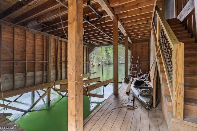 misc room with hardwood / wood-style flooring and a water view