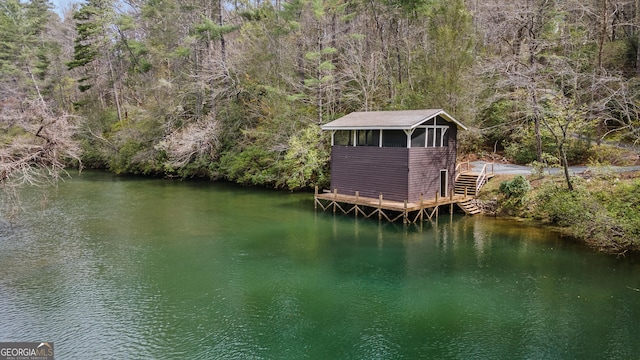 dock area featuring a water view and a forest view