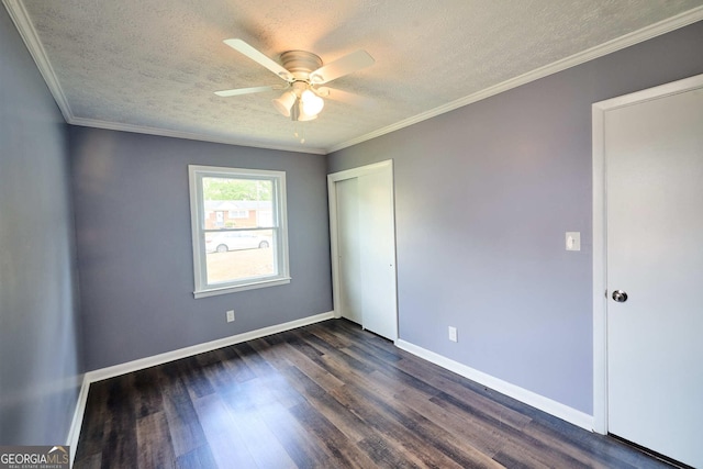 unfurnished bedroom with a textured ceiling, a closet, baseboards, and dark wood finished floors