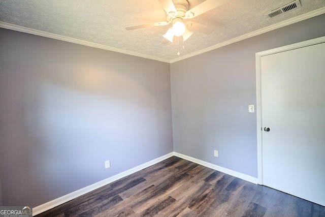 spare room with baseboards, a textured ceiling, a ceiling fan, dark wood-type flooring, and visible vents