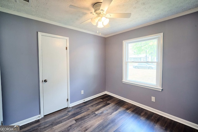 empty room with baseboards, dark wood-type flooring, a textured ceiling, and a ceiling fan