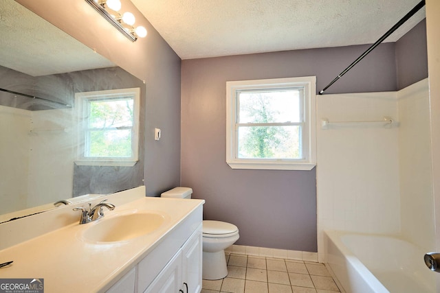 bathroom featuring tile patterned floors, toilet, plenty of natural light, and a textured ceiling