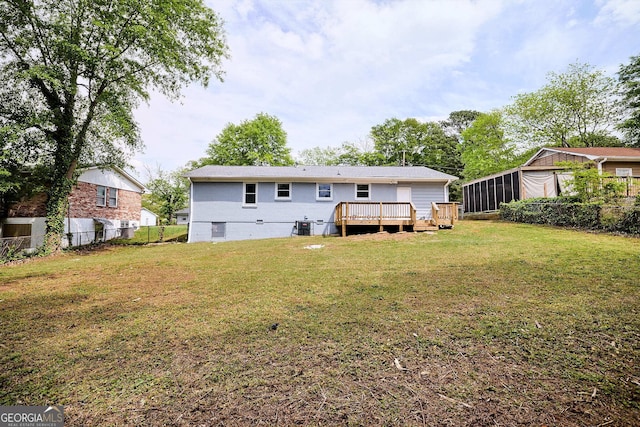 rear view of house with central AC, a sunroom, a yard, fence, and a deck