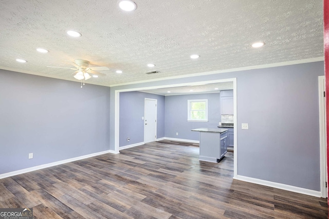 interior space with crown molding, visible vents, ceiling fan, and a textured ceiling