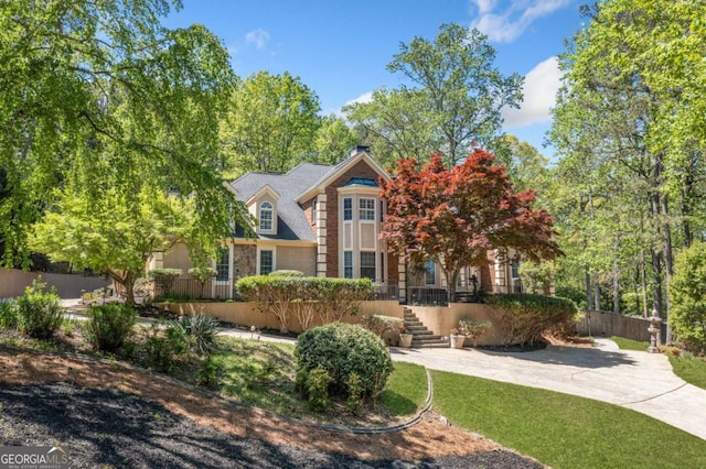 view of front of house featuring fence