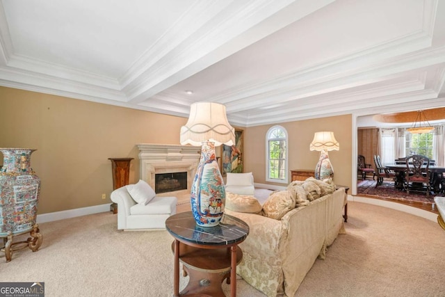carpeted living area featuring a tray ceiling, crown molding, and a healthy amount of sunlight