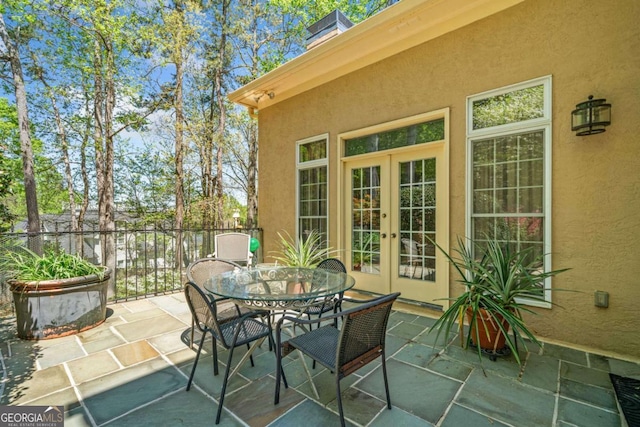 view of patio featuring french doors and outdoor dining area