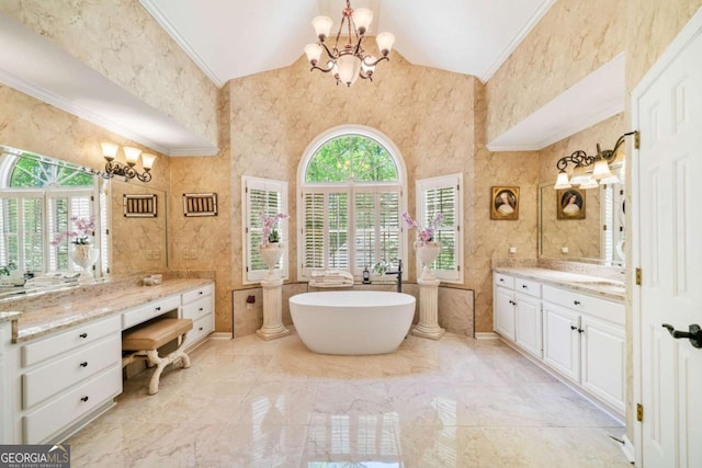 full bathroom with a freestanding tub, a notable chandelier, ornamental molding, and vaulted ceiling