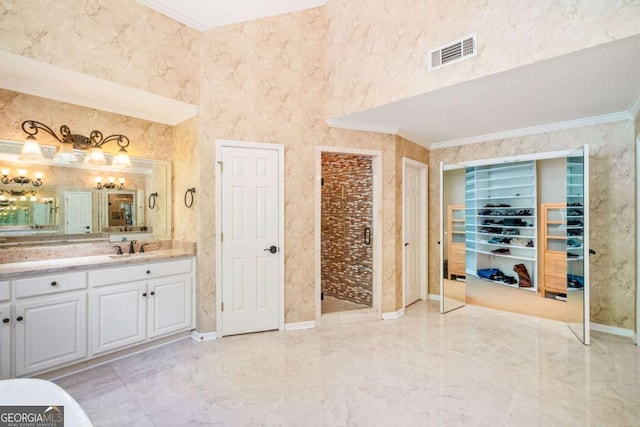 full bath featuring vanity, visible vents, marble finish floor, and crown molding