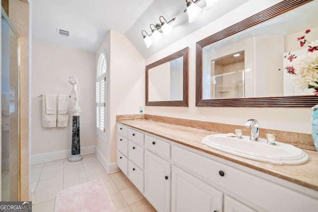 full bathroom featuring vanity, baseboards, tile patterned floors, a shower stall, and visible vents