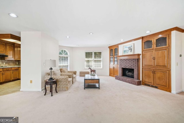 living area with baseboards, recessed lighting, a fireplace, visible vents, and light colored carpet