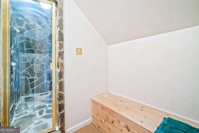 interior space featuring baseboards and lofted ceiling
