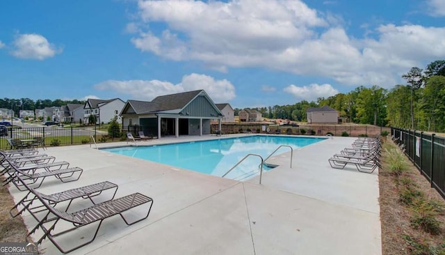 community pool featuring a patio area and fence