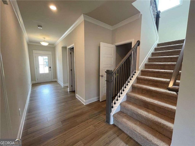 interior space with baseboards, ornamental molding, recessed lighting, stairway, and wood finished floors