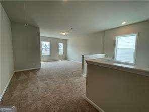 spare room featuring recessed lighting, baseboards, and carpet floors