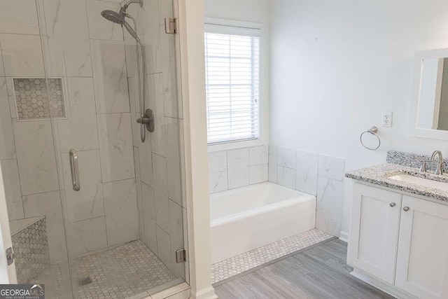 1910 Charleston Oak Cir, Lawrenceville, GA 30043 - bathroom featuring a wealth of natural light, vanity, a bath, and a stall shower