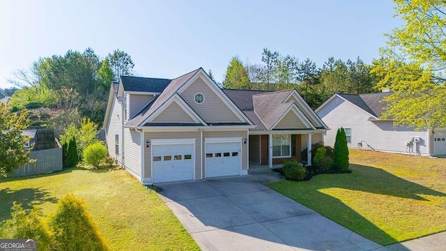 1910 Charleston Oak Cir, Lawrenceville, GA 30043 - view of front of house with a front lawn, fence, an attached garage, and driveway