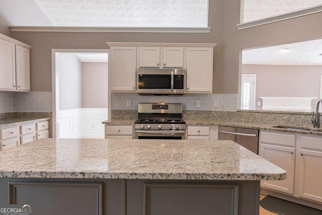 1910 Charleston Oak Cir, Lawrenceville, GA 30043 - kitchen with a healthy amount of sunlight, decorative backsplash, a sink, and stainless steel appliances