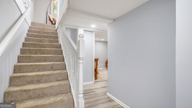 stairway featuring baseboards, recessed lighting, and wood finished floors