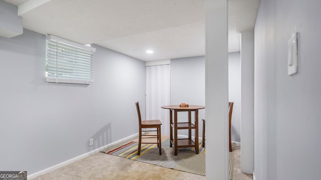 dining space featuring carpet flooring and baseboards
