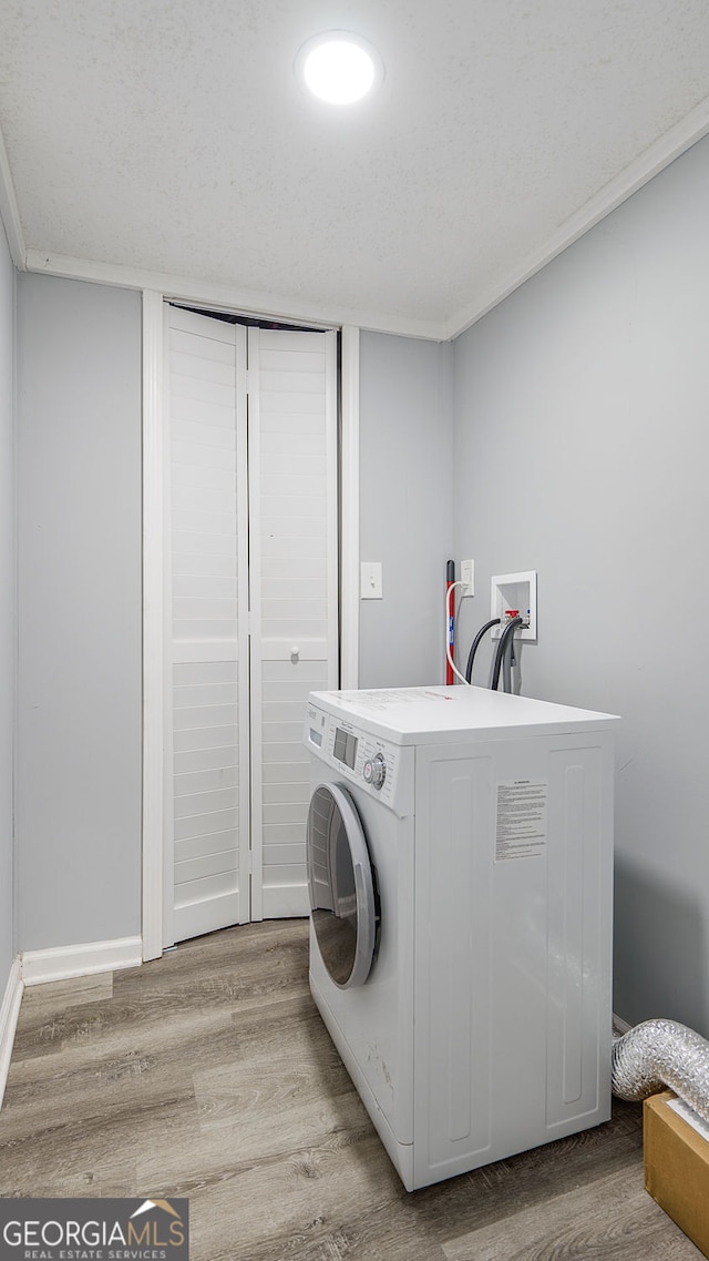 laundry room featuring laundry area, washer / dryer, and light wood-style floors