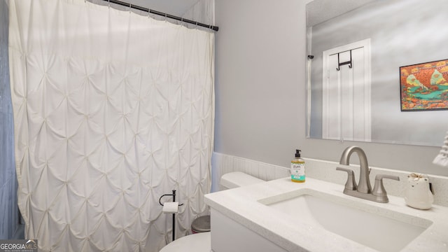 full bath featuring curtained shower, vanity, and toilet