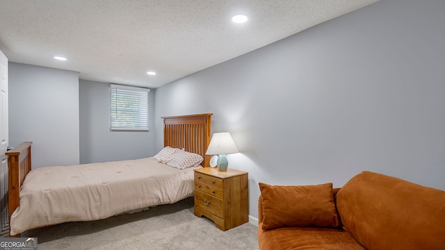 bedroom featuring a textured ceiling, carpet, and recessed lighting