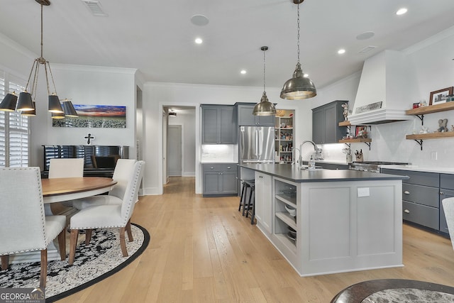 kitchen with custom range hood, gray cabinetry, and open shelves