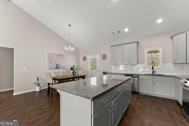 kitchen featuring stainless steel appliances, visible vents, a sink, and dark wood finished floors