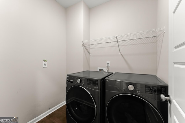 washroom with independent washer and dryer, laundry area, baseboards, and dark wood finished floors