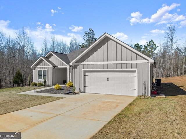 view of front of house with board and batten siding, central AC, a front lawn, an attached garage, and driveway