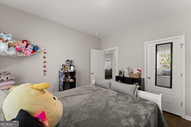 bedroom featuring dark wood-style floors