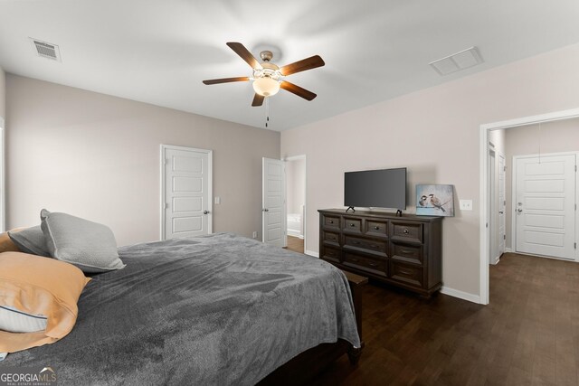 bedroom featuring visible vents, baseboards, ceiling fan, and dark wood finished floors