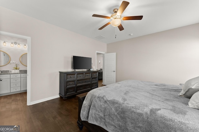 bedroom with baseboards, ensuite bath, a ceiling fan, visible vents, and dark wood finished floors